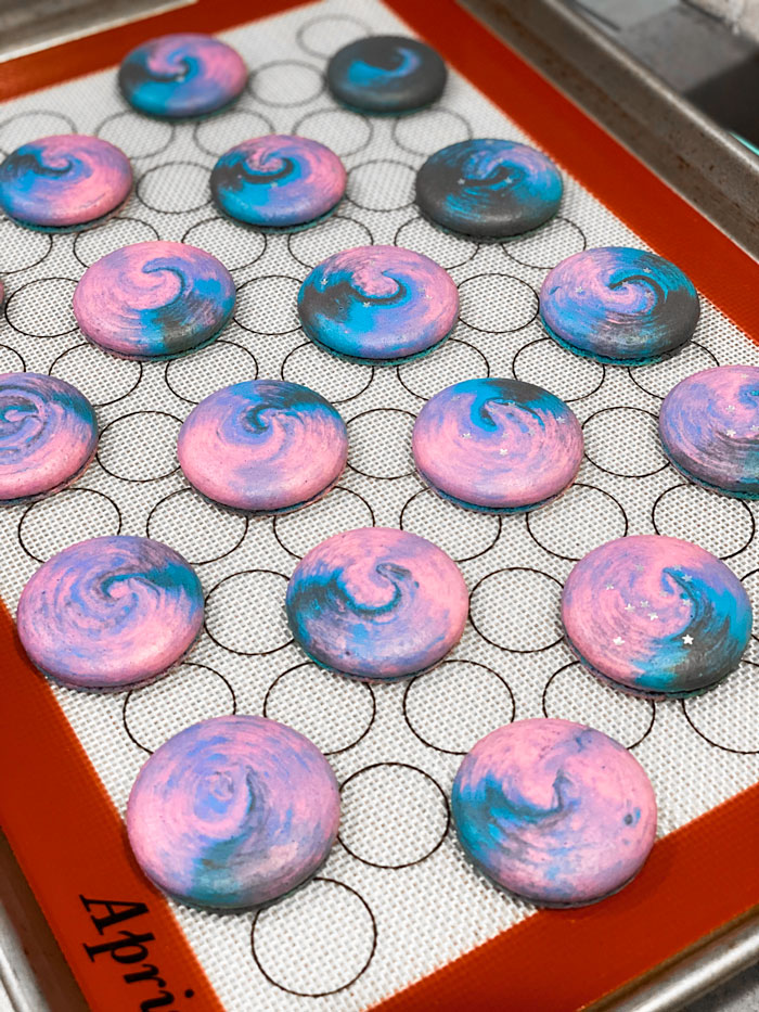 baked galaxy macaron shells on baking mat
