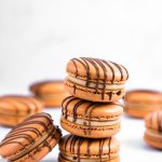 stack of chocolate macarons with chocolate drizzle