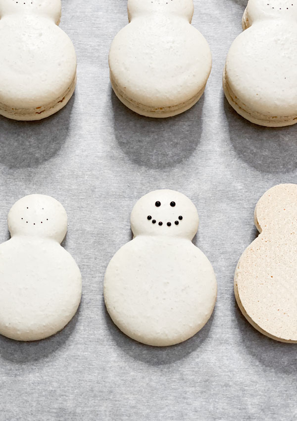snowman macarons decorated with royal icing