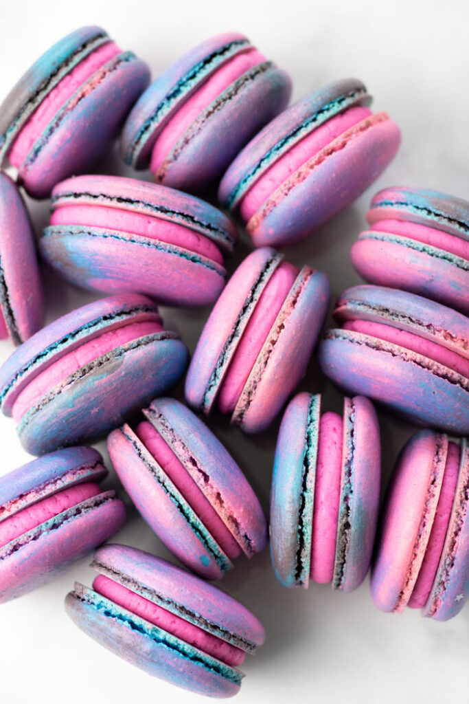 cluster of galaxy macarons with pink buttercream