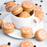 coffee macarons in white coffee mug and white plate