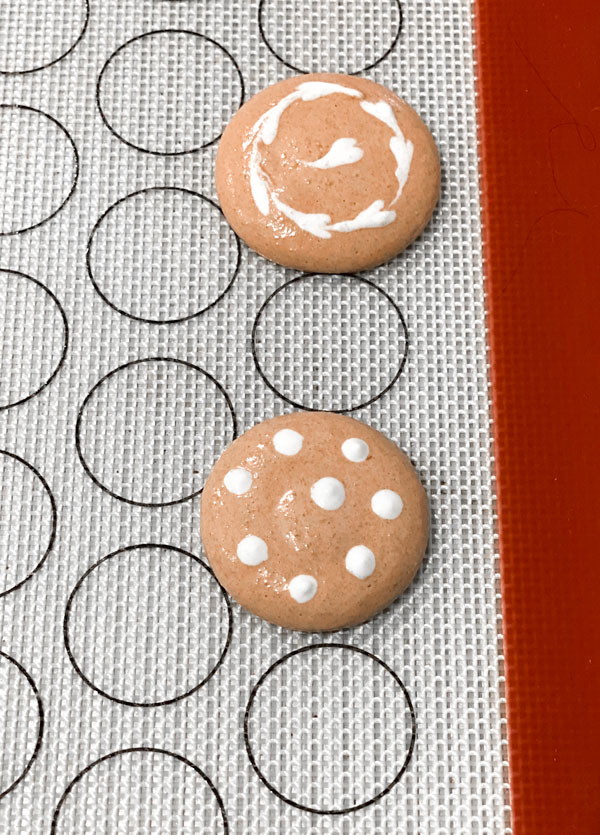 decorated coffee macarons on silicone baking mat