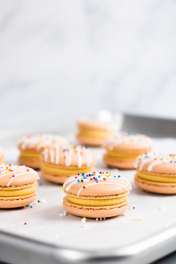 dulce de leche macarons with sprinkles on baking sheet