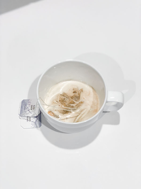 earl grey tea bag in white teacup