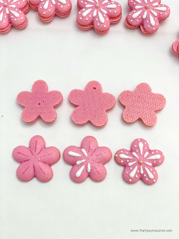 step by step of decorated pink flower shaped macarons with white icing decorations
