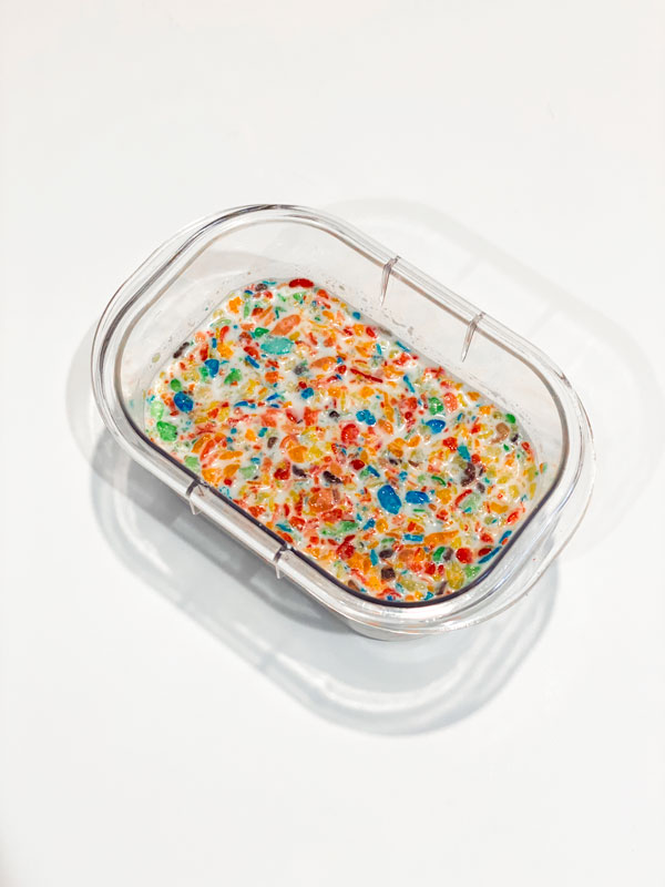 fruity pebbles cereal and milk in plastic container