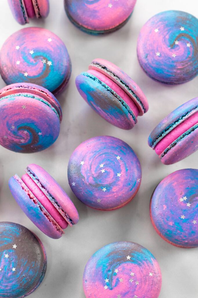 galaxy macarons with silver glitter stars on white background