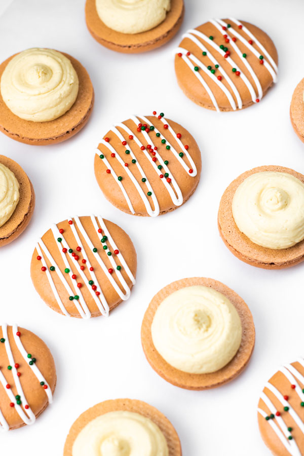 decorated gingerbread macaron shells with buttercream