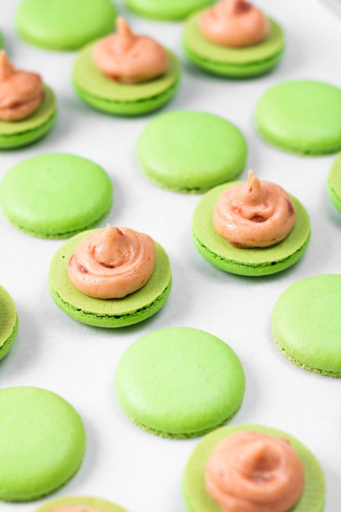 guava macaron shells with buttercream