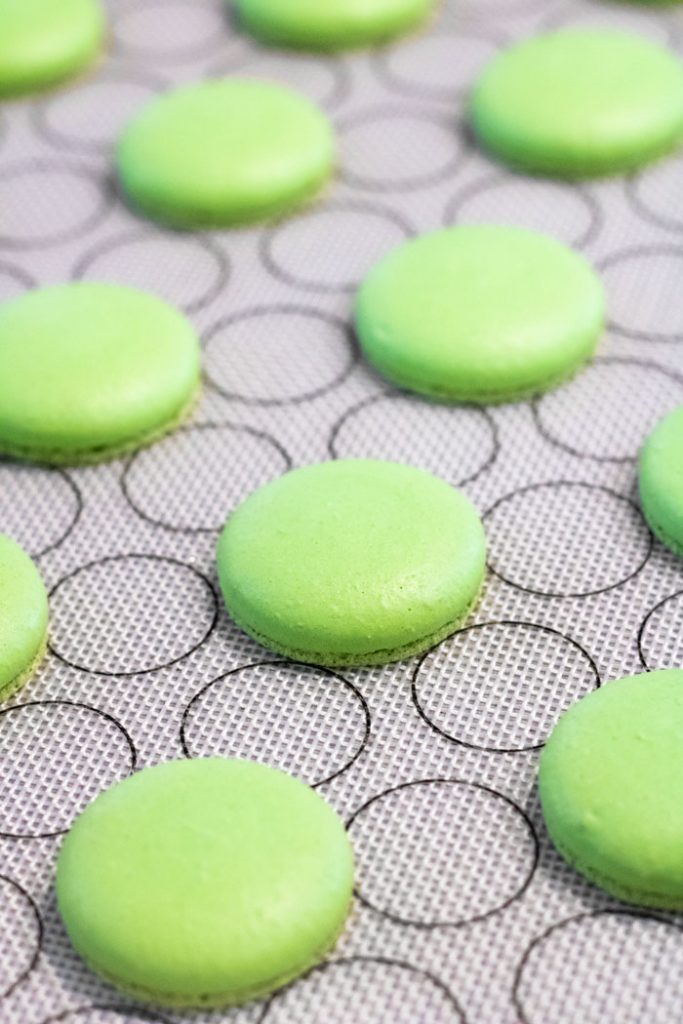 green macaron shells on baking mat