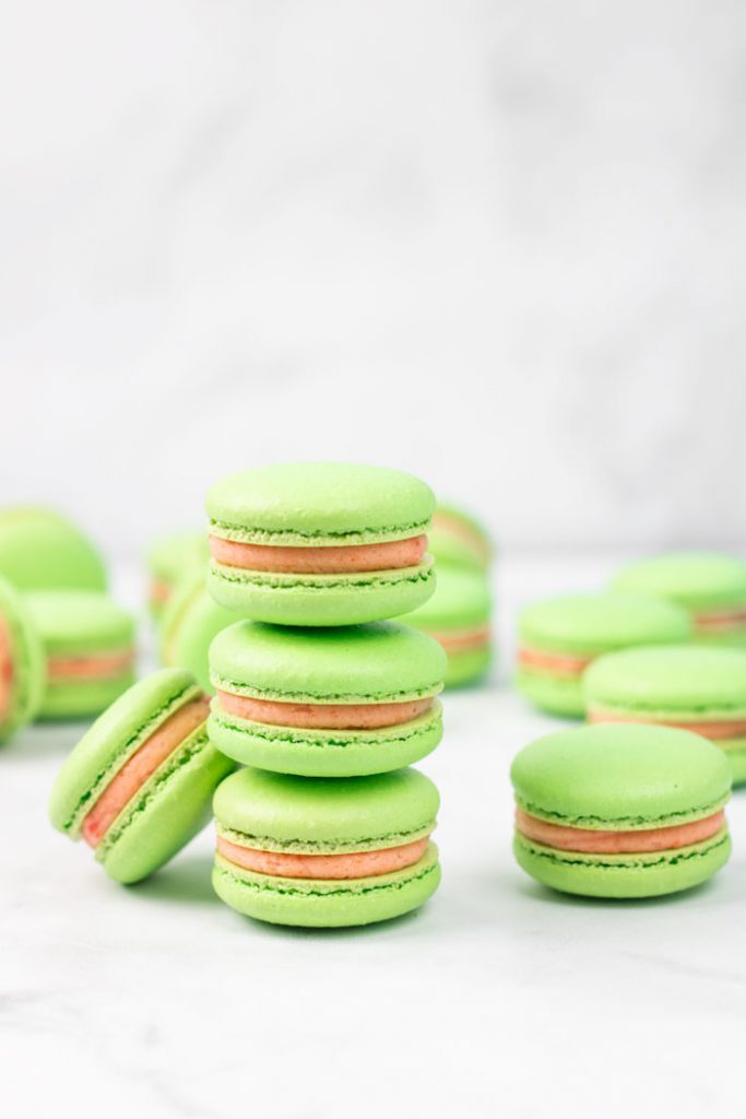 stack of three green guava macarons with guava buttercream