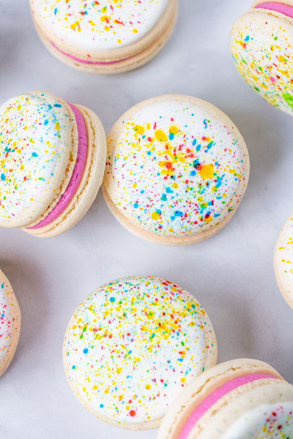 splatter paint macarons with pink buttercream