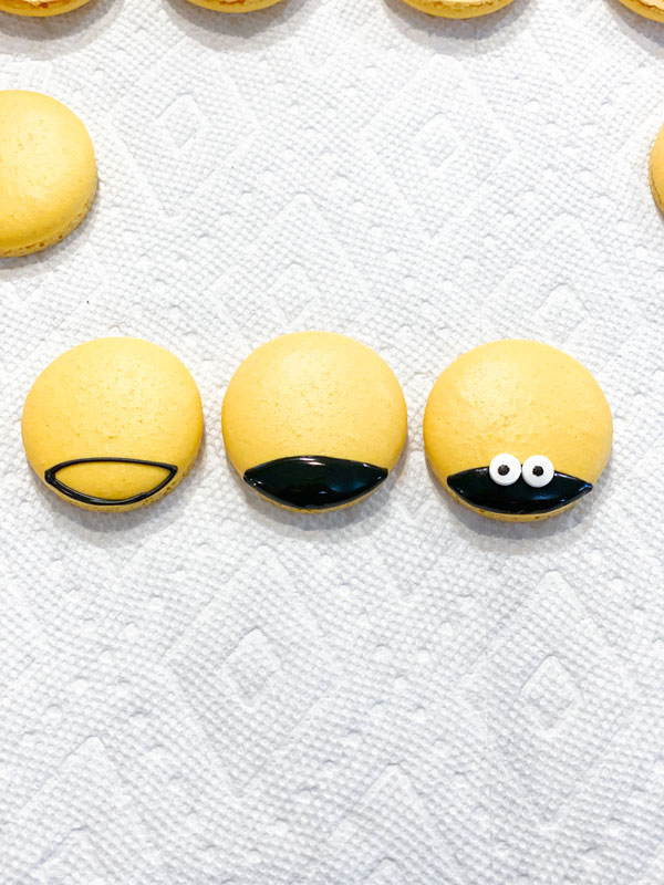 yellow honey macaron shells decorated like bees