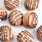 chocolate macarons with chocolate drizzle and mini marshamallow bits