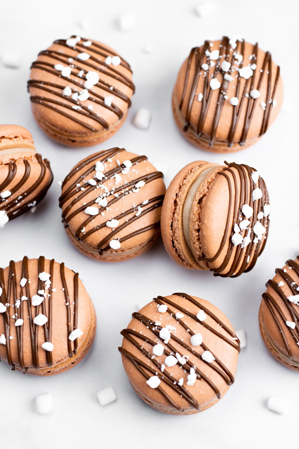 chocolate macarons with chocolate drizzle and mini marshamallow bits