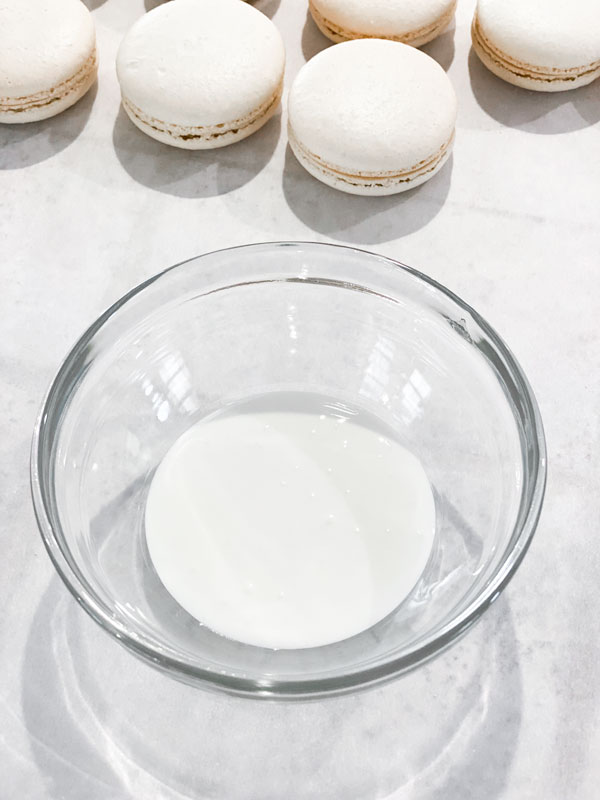 white royal icing in small glass bowl