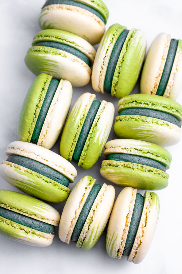 green and white swirled matcha macarons grouped in a pattern
