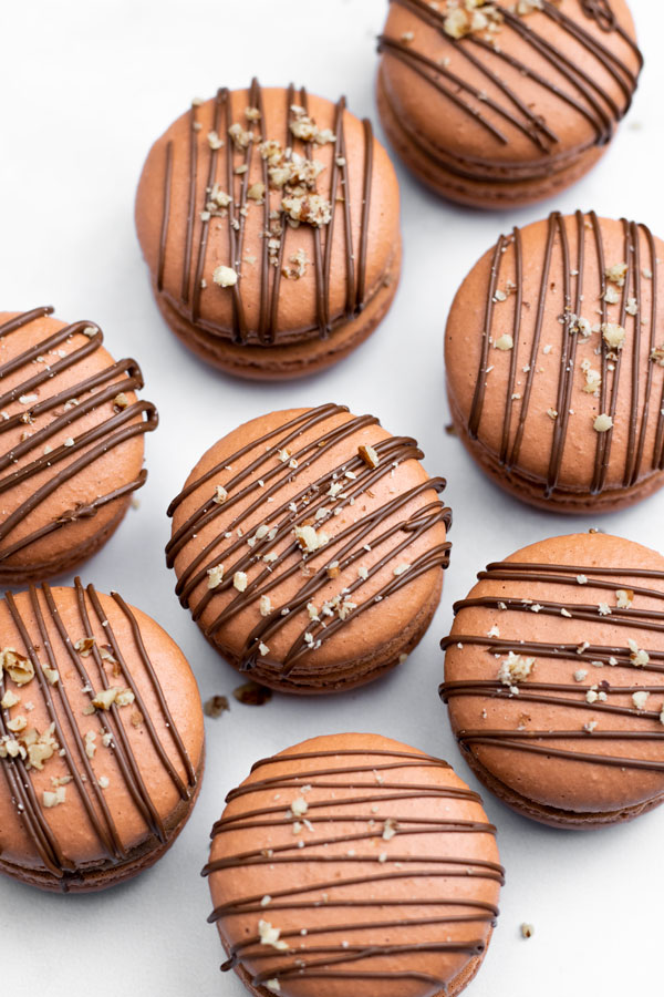 nutella macarons drizzled with chocolate and hazelnuts
