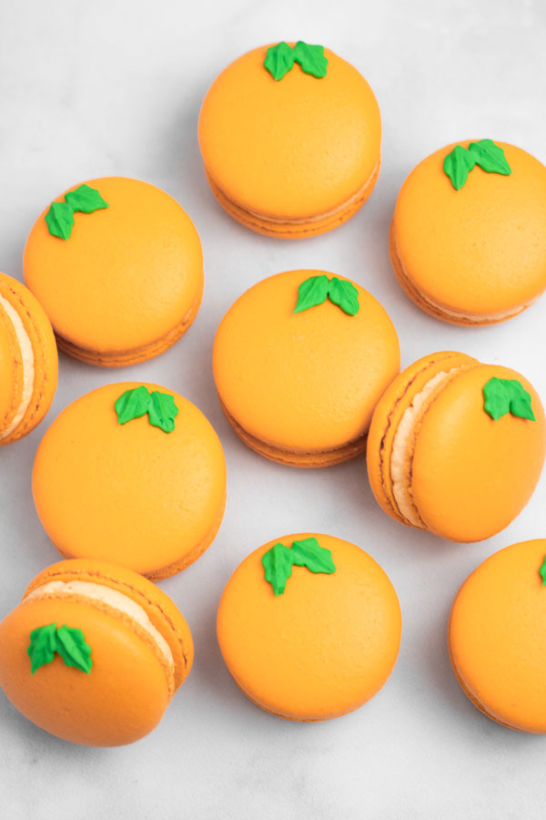 orange macarons on white background