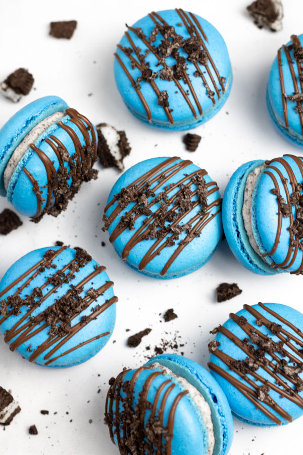 blue oreo macarons with chocolate drizzle and crushed oreos