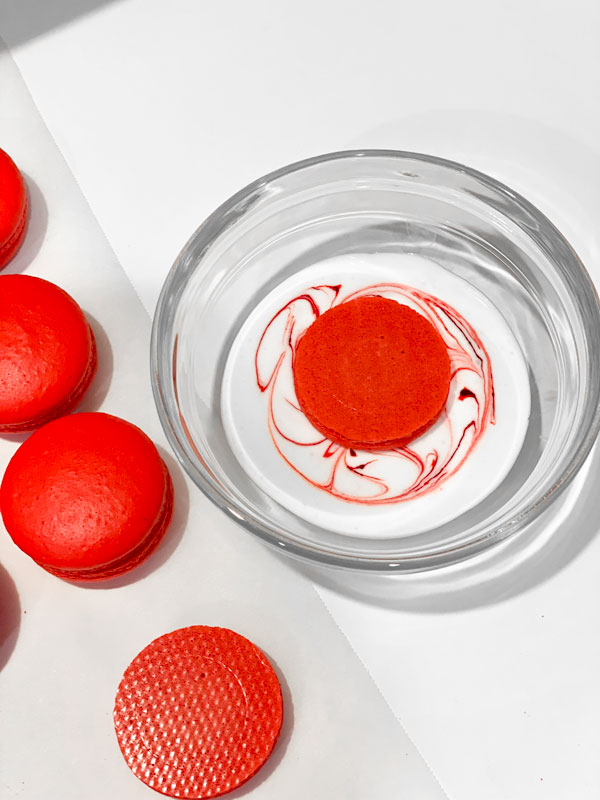 decorated candy cane macarons with marbled royal icing