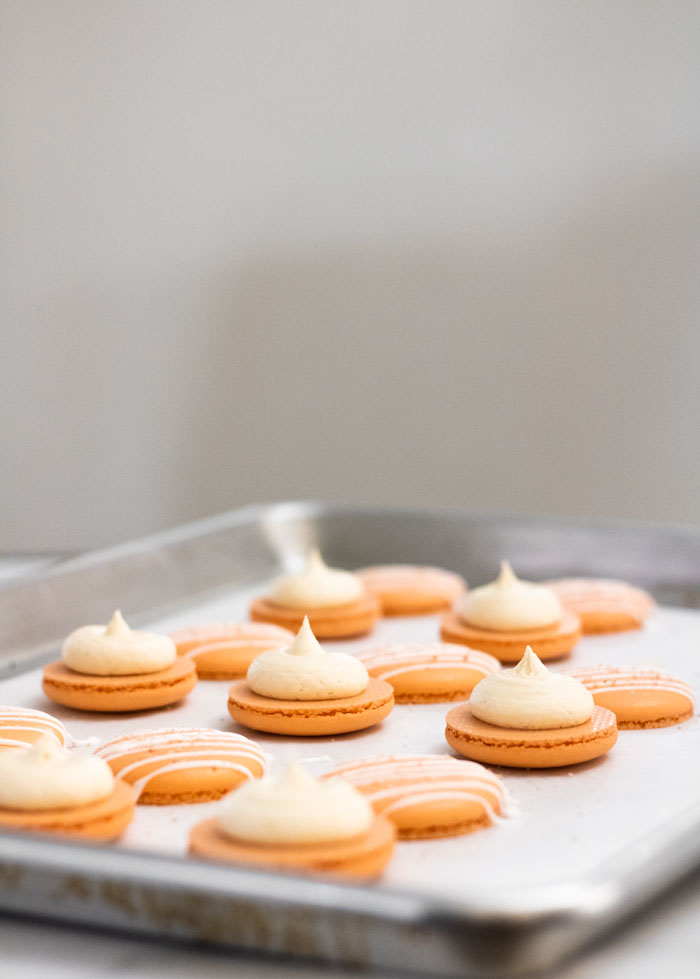 orange salted caramel macarons in baking tray