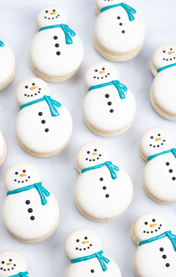 decorated snowman macarons with blue scarf