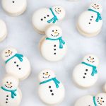 snowman macarons with blue shimmer scarf