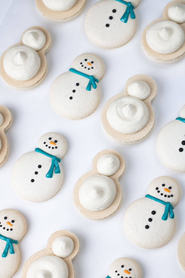 decorated snowman macaron shells with buttercream
