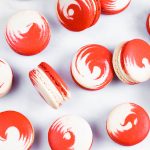 red and white swirled strawberry cheesecake macarons