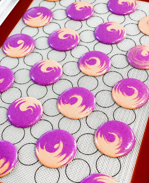 purple and brown swirled macaron peanut butter and jelly macarons macarons on baking sheet