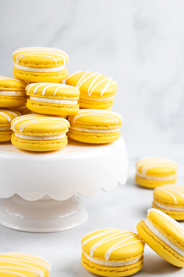 yellow french macarons on white cake stand